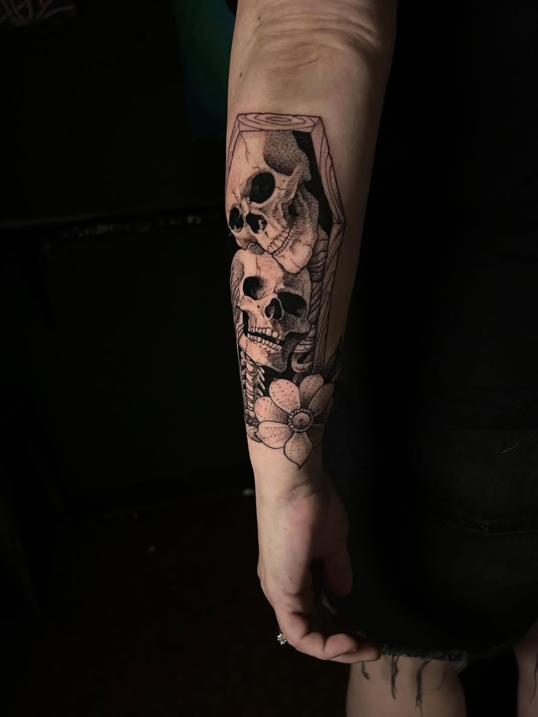 A tattoo of two skeletons.